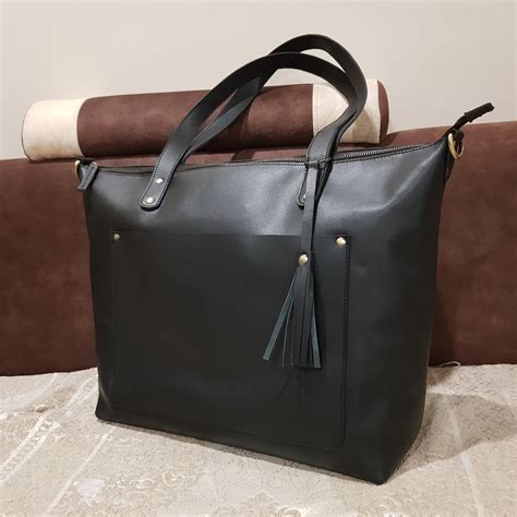 Giant leather tote bag in black .